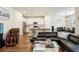 Open-concept living area with a stylish kitchen, comfortable seating, and modern decor at 10815 Windswept Garden Way, Tampa, FL 33647