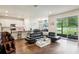 Open-concept living area featuring modern furnishings, kitchen with bar seating and slider to backyard at 10815 Windswept Garden Way, Tampa, FL 33647