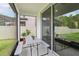 Screened patio with a plastic picnic table and views of the backyard and privacy fence at 10815 Windswept Garden Way, Tampa, FL 33647