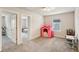 Well-lit playroom featuring window, playhouse, and multiple doorways at 10815 Windswept Garden Way, Tampa, FL 33647