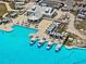 Aerial view of clubhouse featuring a pool, covered seating, and lounge chairs at 10937 Penny Gale Loop, San Antonio, FL 33576