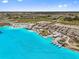 Gorgeous aerial view of community lagoon, beach area, and extensive amenities at 10937 Penny Gale Loop, San Antonio, FL 33576