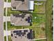 Aerial view of houses with solar panels on the roofs, showcasing the property's community and location at 10937 Penny Gale Loop, San Antonio, FL 33576