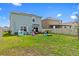 Spacious backyard with lush lawn, outdoor furniture, and play equipment, perfect for recreation at 10937 Penny Gale Loop, San Antonio, FL 33576