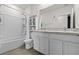 Bright bathroom featuring dual sinks, a bathtub with shower, and ample storage space at 10937 Penny Gale Loop, San Antonio, FL 33576
