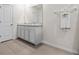 This bathroom has tile floors, a double sink, and a white towel hanging on the wall at 10937 Penny Gale Loop, San Antonio, FL 33576