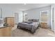 This bedroom features neutral paint, carpet and furnishings, and two large windows at 10937 Penny Gale Loop, San Antonio, FL 33576