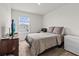 This bedroom features neutral paint, carpet and furnishings, and a television at 10937 Penny Gale Loop, San Antonio, FL 33576