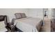 Comfortable bedroom with neutral tones, plush bedding, and convenient access to adjacent areas at 10937 Penny Gale Loop, San Antonio, FL 33576