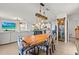 This dining area features a rustic wooden table and a view of the open-concept kitchen at 10937 Penny Gale Loop, San Antonio, FL 33576