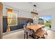 Bright dining room with wooden table, bench, and chairs near sliding glass door at 10937 Penny Gale Loop, San Antonio, FL 33576