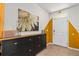 Stylish entryway with modern storage cabinet, sunflower painting, and bright white door at 10937 Penny Gale Loop, San Antonio, FL 33576