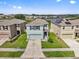 A beautifully landscaped two-story home boasting a well-maintained lawn and a charming facade at 10937 Penny Gale Loop, San Antonio, FL 33576