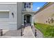 Inviting front entrance featuring a walkway lined with lights and a comfortable outdoor seating area at 10937 Penny Gale Loop, San Antonio, FL 33576