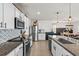 Bright kitchen boasts granite countertops, a stainless steel refrigerator, and subway tile backsplash at 10937 Penny Gale Loop, San Antonio, FL 33576