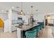 Modern kitchen with an island, stainless steel appliances, and bright barstools at 10937 Penny Gale Loop, San Antonio, FL 33576