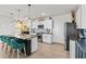 Modern kitchen features a large island with seating, granite countertops, and stainless steel appliances at 10937 Penny Gale Loop, San Antonio, FL 33576