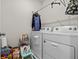 Functional laundry room equipped with a washer, dryer, and storage solutions at 10937 Penny Gale Loop, San Antonio, FL 33576