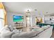 The living room features a comfortable sofa and a modern entertainment center at 10937 Penny Gale Loop, San Antonio, FL 33576
