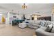 Open-concept kitchen and living room with island, barstools, and comfortable sectional couch at 10937 Penny Gale Loop, San Antonio, FL 33576