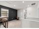 The loft features a dark accent wall, neutral carpet, and lots of natural light at 10937 Penny Gale Loop, San Antonio, FL 33576