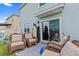 Outdoor patio with comfortable wicker furniture, perfect for relaxing or entertaining with sliding glass doors and ample sunlight at 10937 Penny Gale Loop, San Antonio, FL 33576
