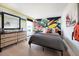 Trendy bedroom with a sleek bed, colorful graffiti art, and modern furniture at 12164 Cattleside Dr, Riverview, FL 33579