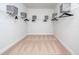 Spacious walk-in closet with white wire shelving and gray storage boxes, perfect for organization at 12164 Cattleside Dr, Riverview, FL 33579