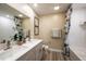 Bathroom features double sinks, a decorative mirror, patterned shower curtain, and tiled walls at 12168 Cattleside Dr, Riverview, FL 33579
