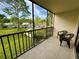 Relaxing screened balcony with outdoor seating and views of the community at 1423 Pine Glen Ln # D2, Tarpon Springs, FL 34688