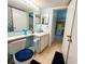Cozy bathroom featuring a sink, toilet, and mirror, with access to in-unit laundry at 1423 Pine Glen Ln # D2, Tarpon Springs, FL 34688