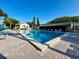 Community pool with lounge chairs and clear blue skies at 1423 Pine Glen Ln # D2, Tarpon Springs, FL 34688