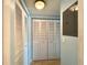 Hallway with a closet with bifold doors and laminate floors at 1423 Pine Glen Ln # D2, Tarpon Springs, FL 34688