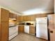Eat-in kitchen features a refrigerator, stove, dishwasher, and built-in microwave at 1423 Pine Glen Ln # D2, Tarpon Springs, FL 34688