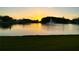 Scenic sunset view overlooking a tranquil pond with a fountain, creating a serene and picturesque landscape at 1423 Pine Glen Ln # D2, Tarpon Springs, FL 34688