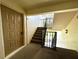 Apartment stairwell with front door and stairs with black rails at 1423 Pine Glen Ln # D2, Tarpon Springs, FL 34688