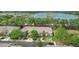 Aerial view of townhomes with garages, driveways, and proximity to a lake and lush greenery at 2009 River Turia Cir, Riverview, FL 33578