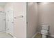 This bathroom features a glass enclosed shower, toilet, door and towel rack at 2009 River Turia Cir, Riverview, FL 33578