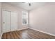 A simple bedroom with wood floors, closet, window, and electrical outlets at 2009 River Turia Cir, Riverview, FL 33578