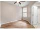 Cozy bedroom with wood-look flooring, ceiling fan, and a window at 2009 River Turia Cir, Riverview, FL 33578