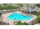 Aerial view of a community pool with an open air clubhouse, tables, chairs and lounge furniture at 2009 River Turia Cir, Riverview, FL 33578