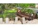 View of walkway over wetlands with lounge chairs, landscaping and community gate at 2009 River Turia Cir, Riverview, FL 33578