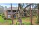 Exterior view of a two-story condominium building with a screened in porch and mature trees at 2009 River Turia Cir, Riverview, FL 33578
