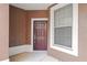 Inviting front entrance with a classic-style door and adjacent window at 2009 River Turia Cir, Riverview, FL 33578