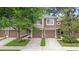 Two-story townhome featuring attached garages and well-manicured landscaping at 2009 River Turia Cir, Riverview, FL 33578