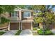 Two-story townhome featuring attached garages and well-manicured landscaping at 2009 River Turia Cir, Riverview, FL 33578