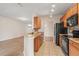 Updated kitchen with granite countertops and stainless steel appliances, overlooks living area at 2009 River Turia Cir, Riverview, FL 33578