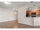 The kitchen features brown cabinets and black appliances with views to the living spaces at 2009 River Turia Cir, Riverview, FL 33578