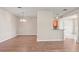 Bright living room with modern wood floors and a view of the kitchen at 2009 River Turia Cir, Riverview, FL 33578