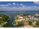 Wide aerial view of waterfront property with private dock and boat surrounded by other homes in the area at 2063 Illinois Ne Ave, St Petersburg, FL 33703